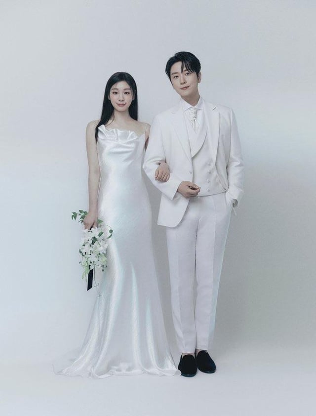 Chú rể Ko Woo Rim và cô dâu Kim Yuna rạng rỡ trong ảnh cưới, thể hiện niềm hạnh phúc của cặp đôi nghệ sĩ và vận động viên